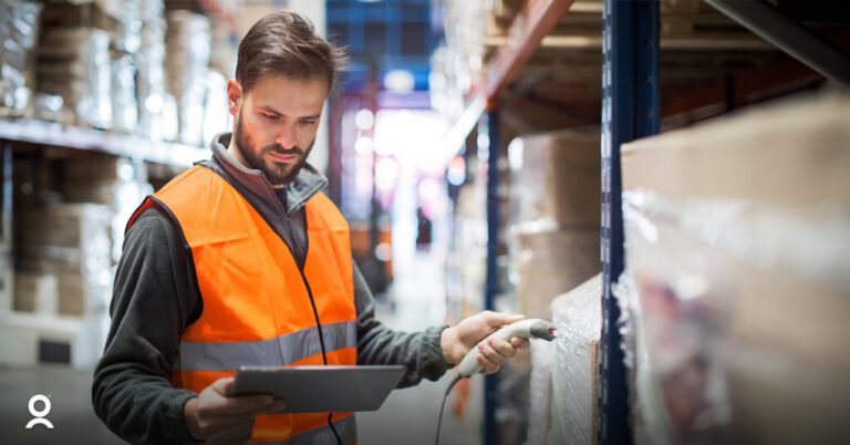 warehouse worker in reflective vest doing inventory