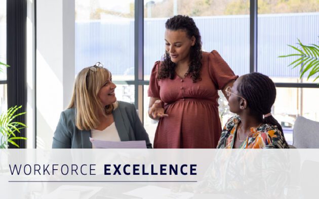 Three women in business attire discuss employee experience around a table in a modern office, with the text "Workforce Excellence" displayed at the bottom of the image.