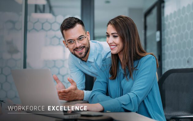 Two people in blue shirts sit at a desk, looking at a laptop and smiling. The words "WORKFORCE EXCELLENCE" appear in the lower left corner.