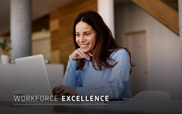 A woman in a blue shirt sits at a desk, smiling at her laptop. The text "WORKFORCE EXCELLENCE" appears at the bottom of the image.