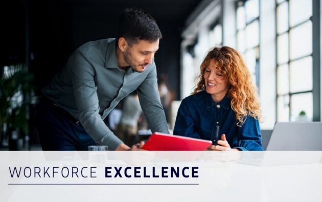 A man and woman in a modern office review a red folder together. Text overlay reads “Workforce Excellence.”.
