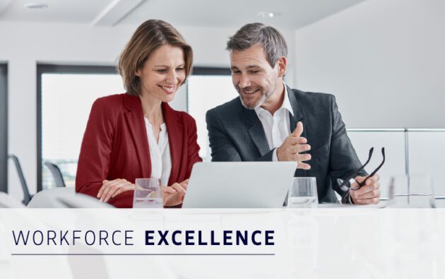 Two professionally dressed people are sitting at a desk, looking at a laptop and smiling. Text in the image reads "WORKFORCE EXCELLENCE.