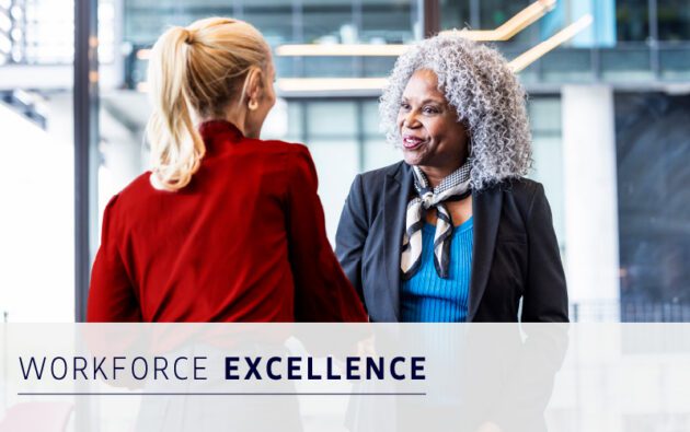 Two women in business attire shake hands and smile in an office setting. The text “WORKFORCE EXCELLENCE” is displayed at the bottom of the image.